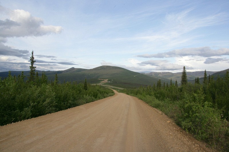 The Top of the World Highway ribbons off in the distance.