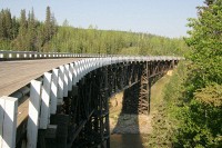 The Kiskatinaw Bridge is the longest wood curved bridge in North America and spans the Kiskatinaw River.