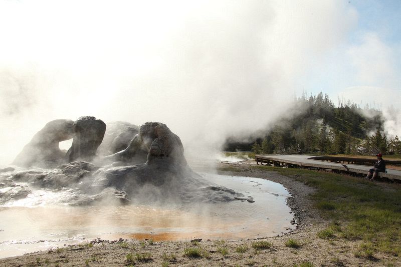 Walking around the geyser fields at Old Faithful - Michelle taking in the steam.
